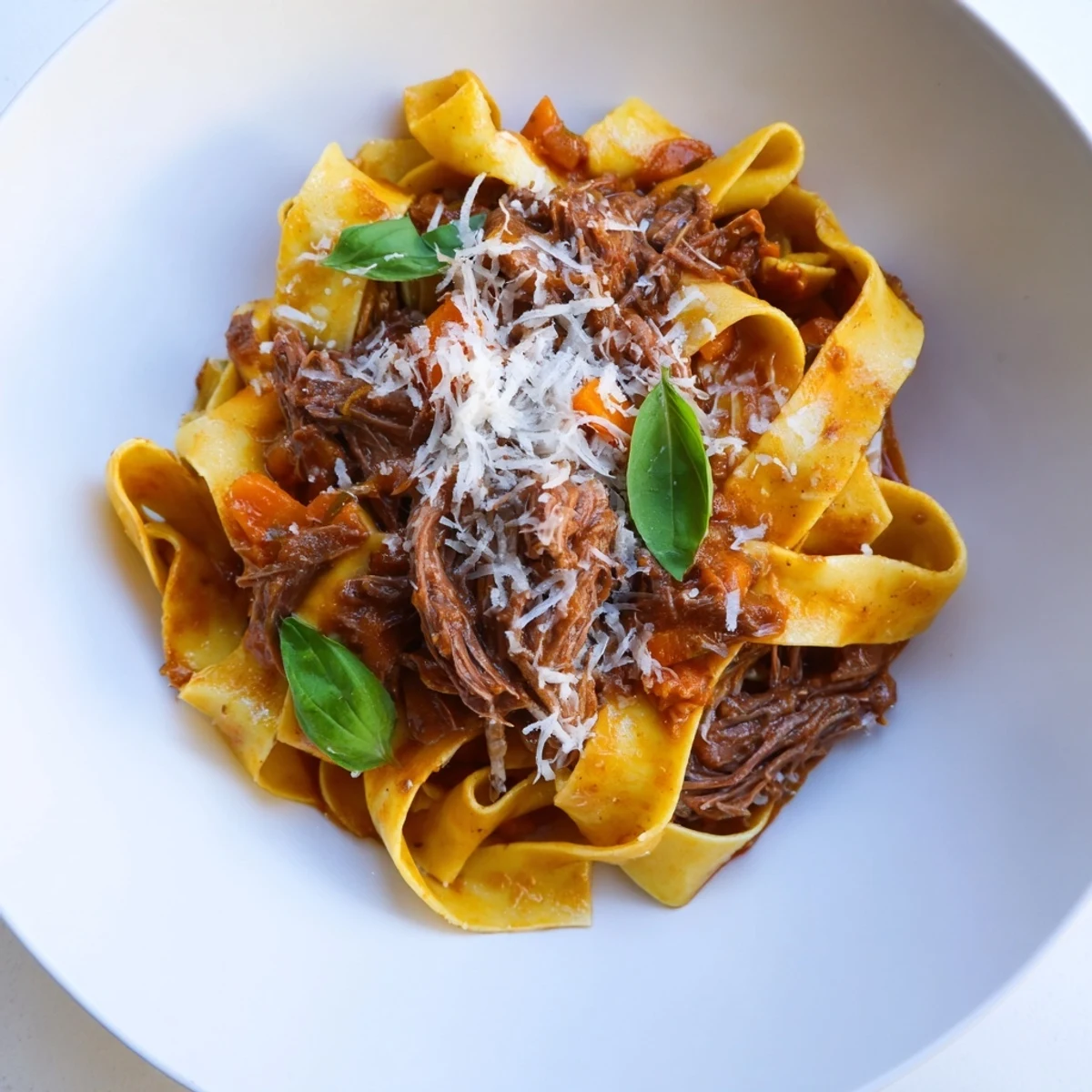 Steaming slow cooker beef ragu, rich and savory, tossed with pappardelle pasta and creamy Parmesan.
