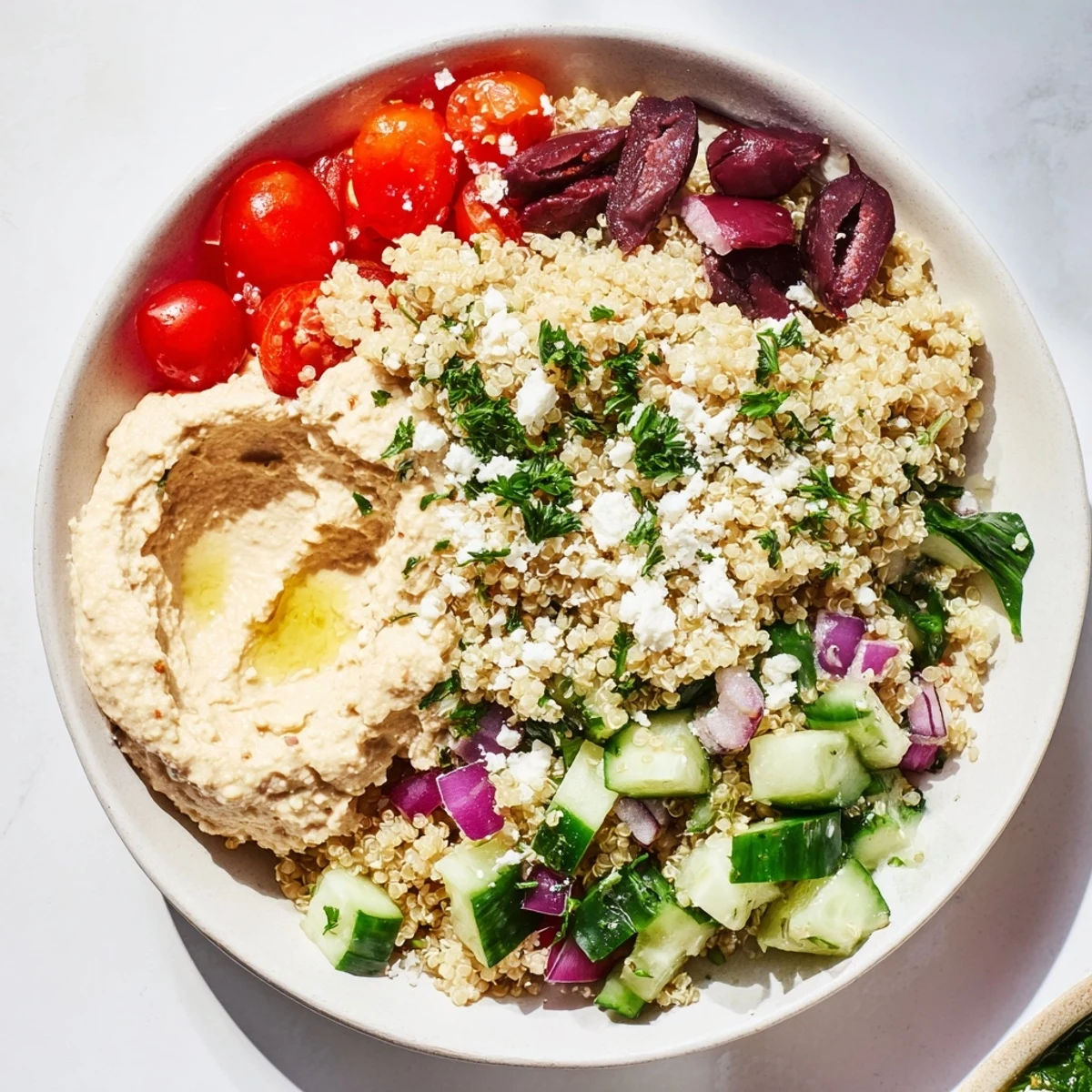 Freshly assembled Mediterranean Quinoa Bowl with Hummus, ready to serve with vibrant garnishes.