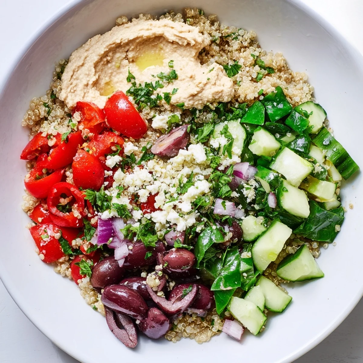 A delicious vegetarian Mediterranean Quinoa Bowl with Hummus, showcasing textures and flavors.