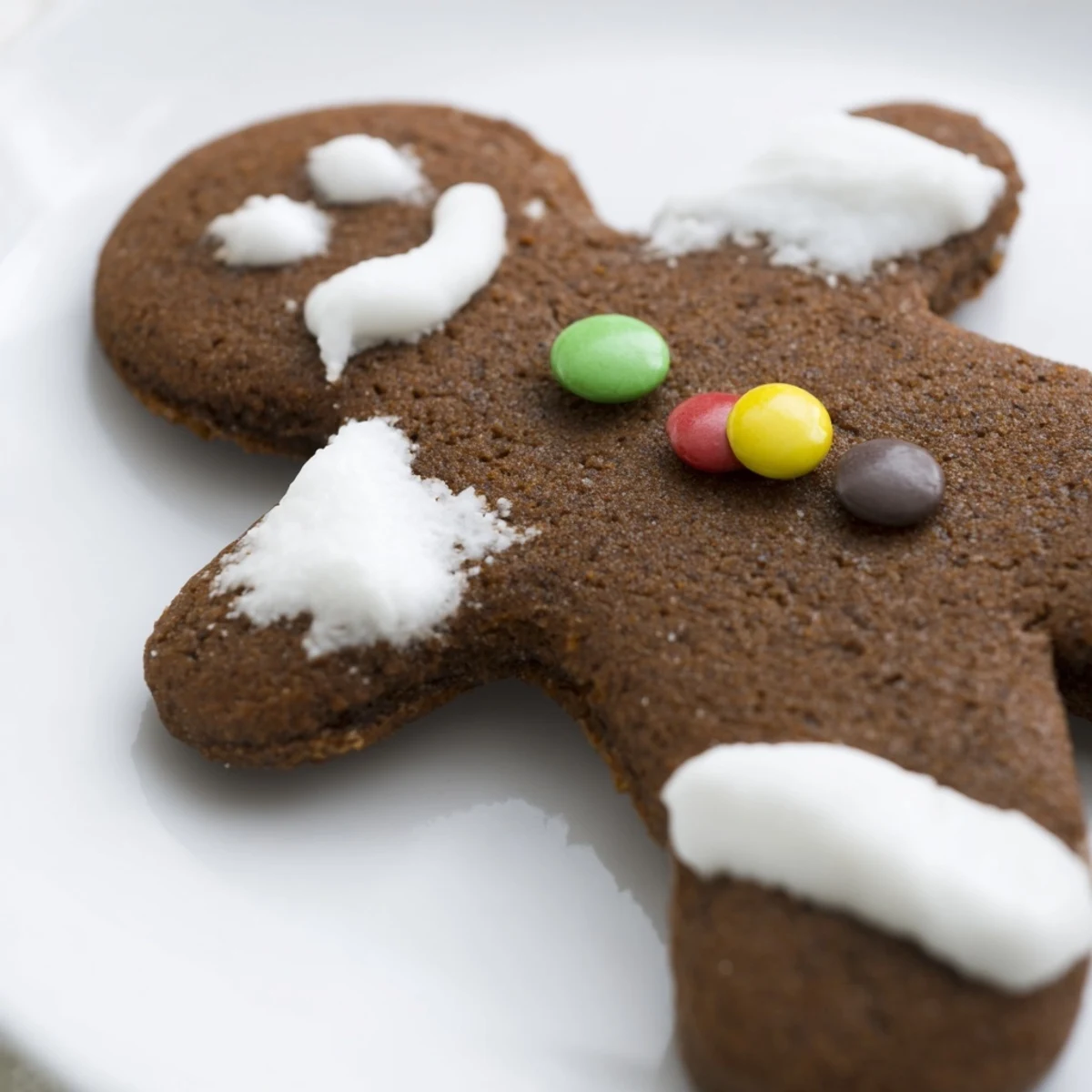 Festively decorated Gingerbread Man with Buttons cookies, complete with colorful candy buttons and warm spiced aromas.