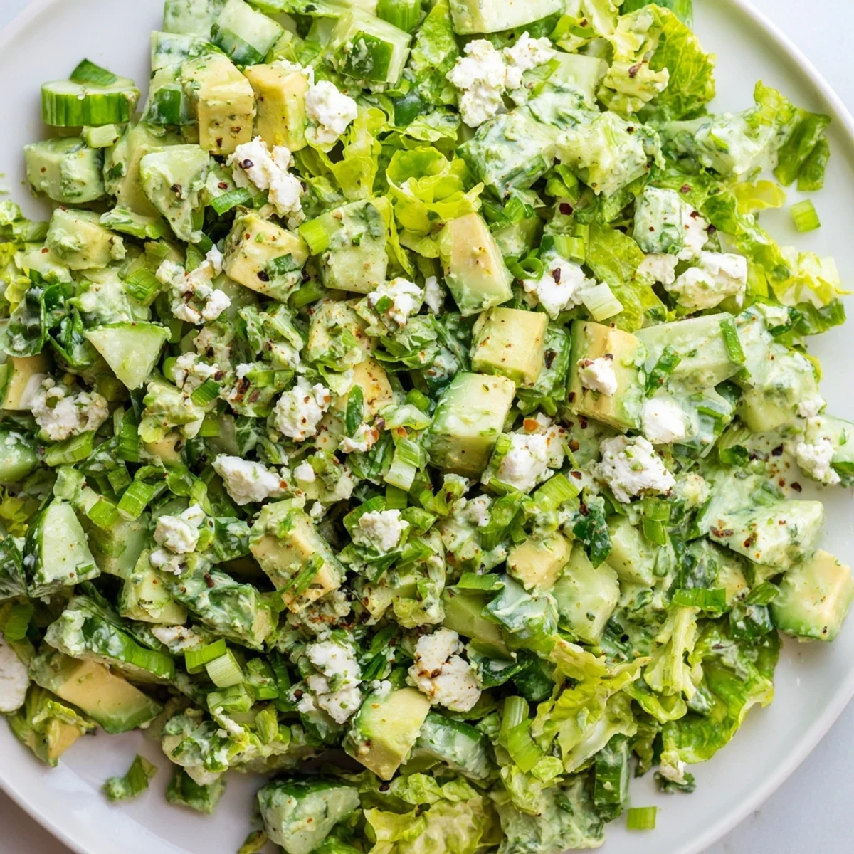 Fresh diced cucumbers and creamy avocado tossed in a vibrant Green Goddess Salad with fresh herbs.
