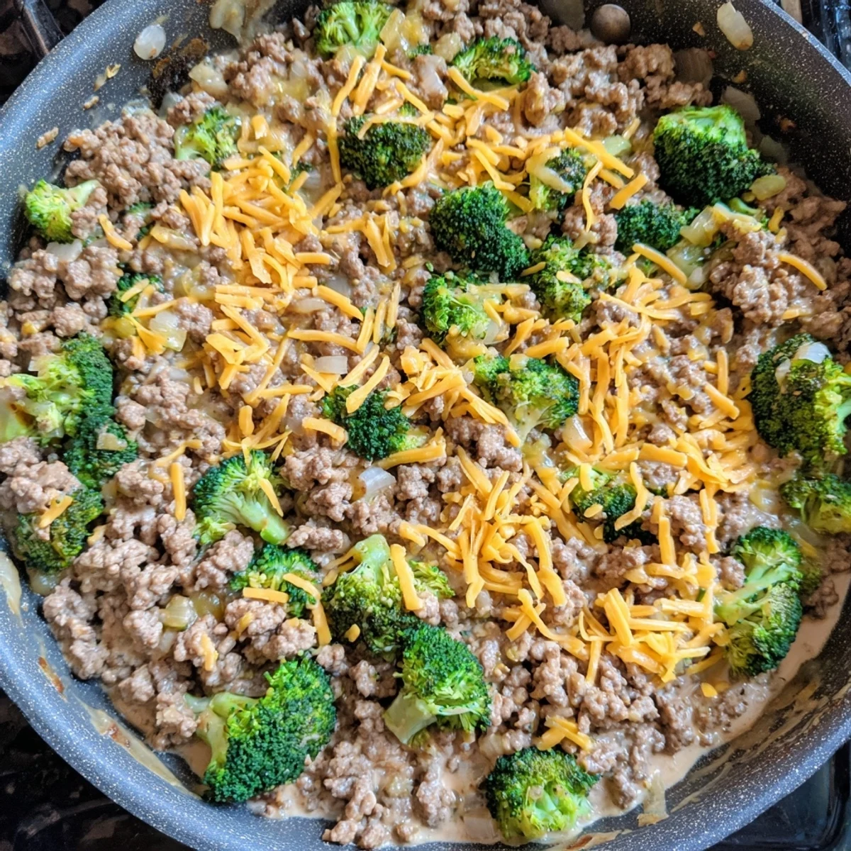 Golden melted cheddar blankets the Keto Hamburger Broccoli Skillet with seasoned beef and tender green florets.