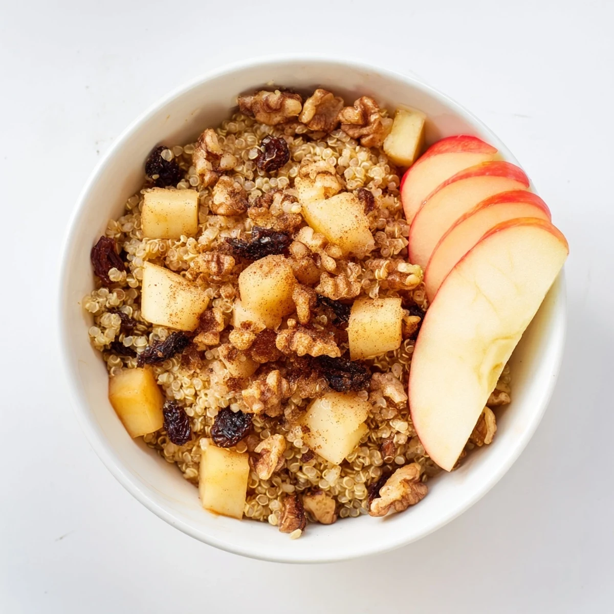 Healthy Quinoa Apple Breakfast with fluffy grains, diced apples, and raisins, ready to eat for breakfast.