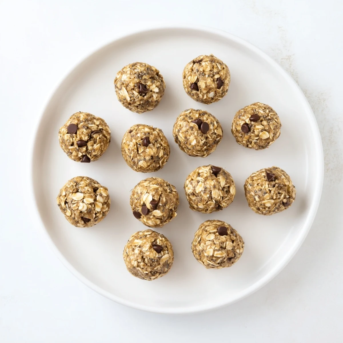 Cool mint protein balls with chocolate chips on a wooden board, showing a chewy texture for a healthy snack.