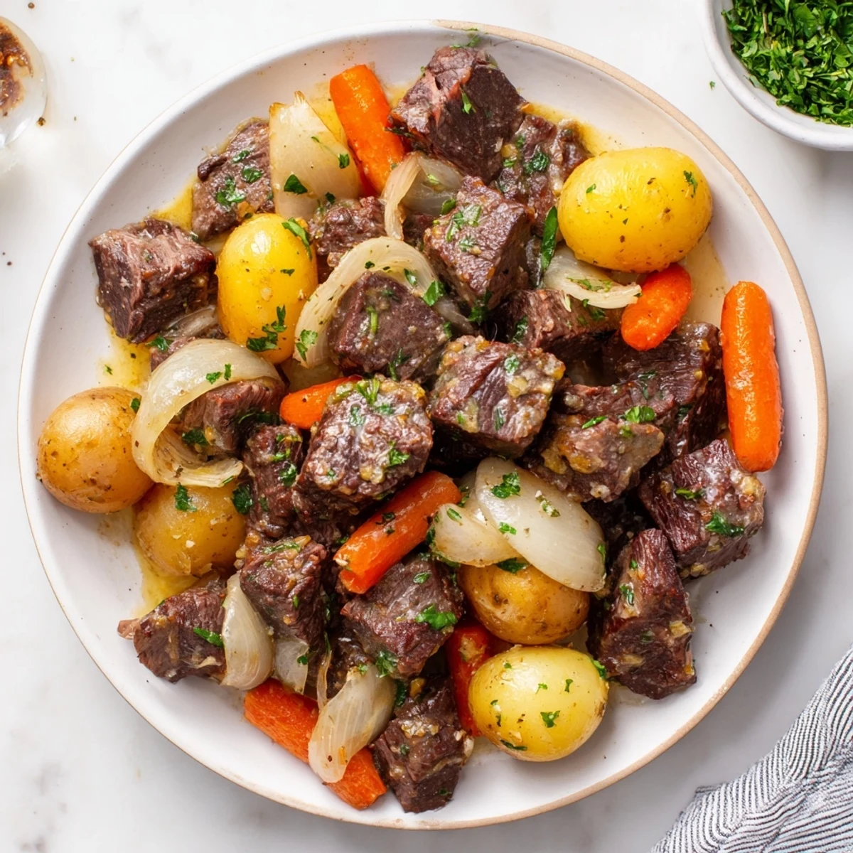 Golden potatoes and tender beef chunks in a savory garlic butter glaze, ready to serve with steamed green beans.