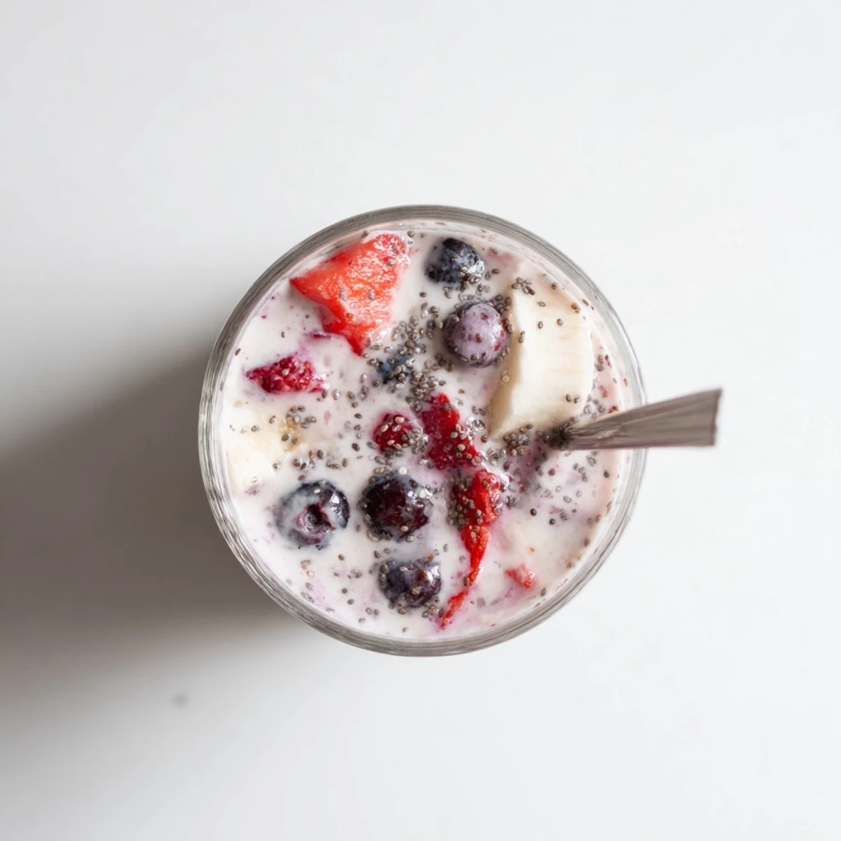 Thick purple Greek yogurt breakfast smoothie topped with fresh strawberries and chia seeds