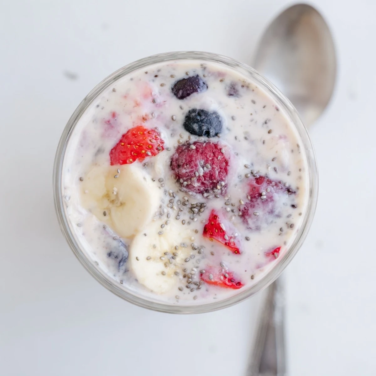 Creamy Greek yogurt breakfast smoothie blended with mixed berries and banana in a tall glass