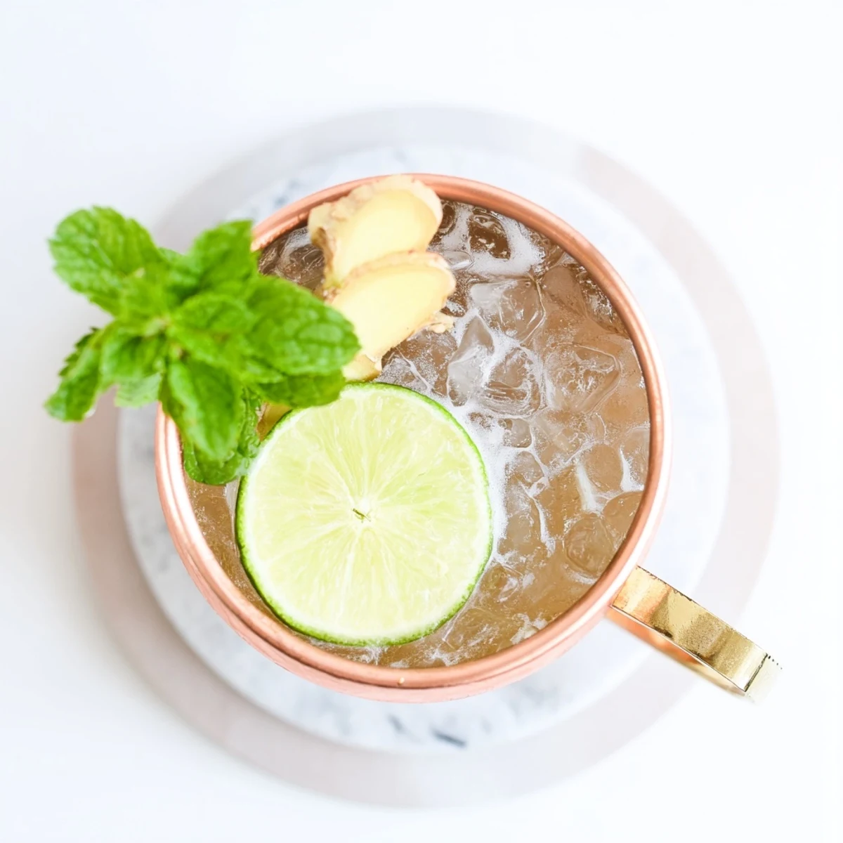 Ginger beer Virgin Moscow Mule with club soda, lime wedge, and aromatic mint in copper mug