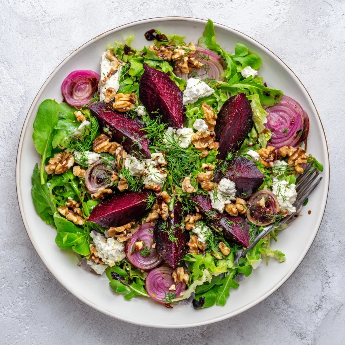 Fresh ultimate beet salad plated with tangy vinaigrette crumbled cheese and crunchy walnut topping
