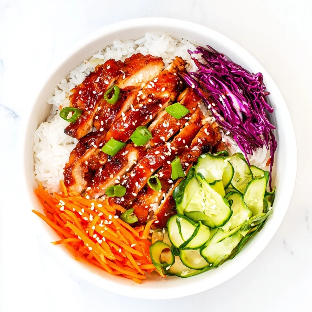 Golden charred chicken thighs over fluffy rice with crisp colorful vegetables in Korean BBQ chicken bowls