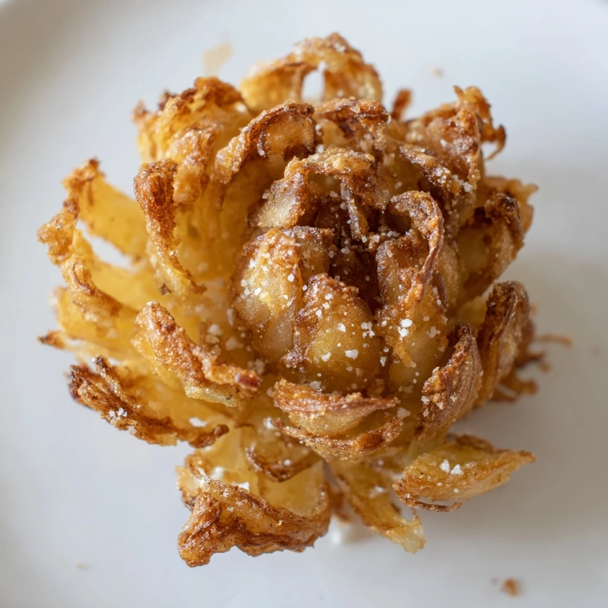 A plate of crispy mini bloomin onions recipe surrounded by spicy mayo dip for sharing