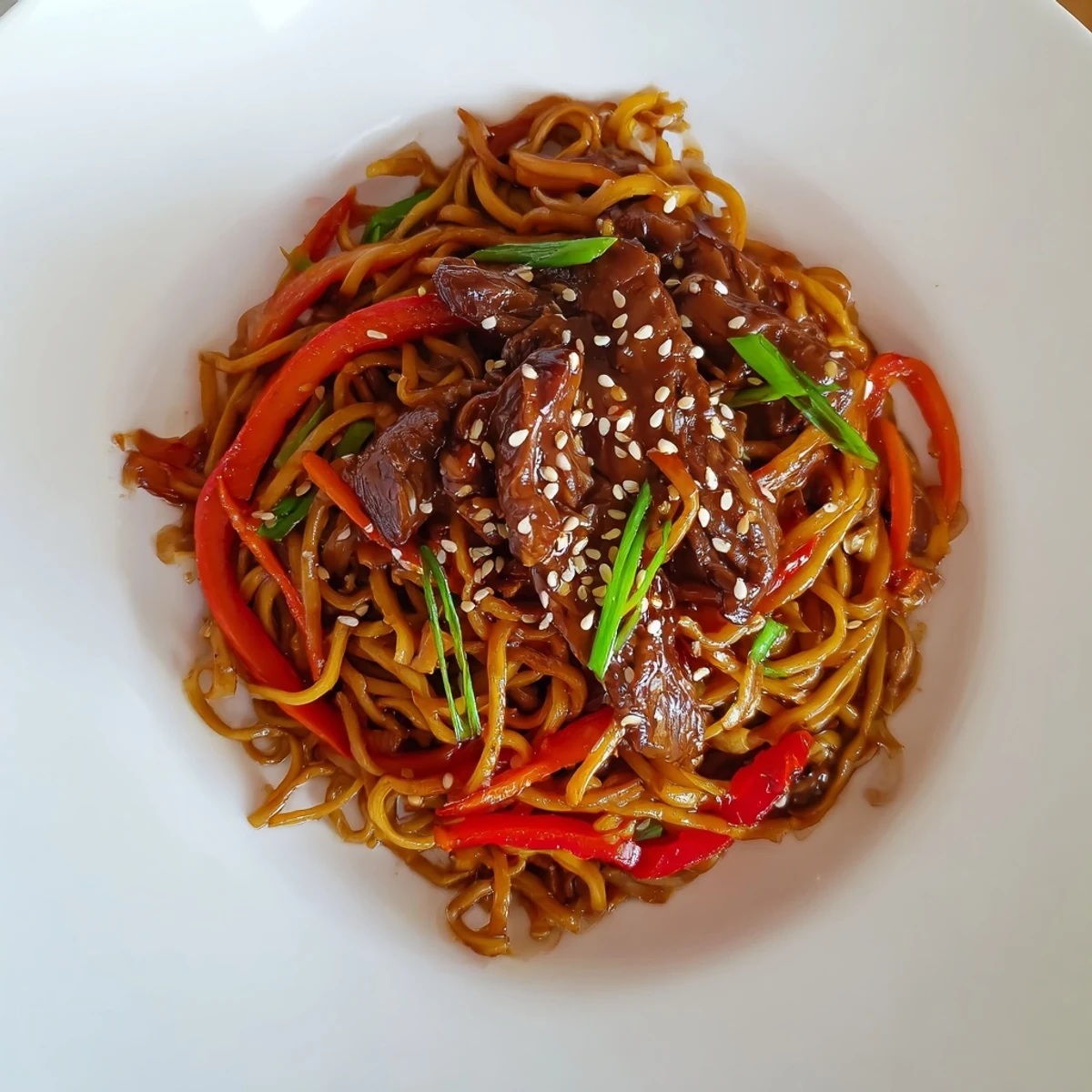 Sticky Beef Noodles tossed in caramelized hoisin sauce, topped with toasted sesame seeds