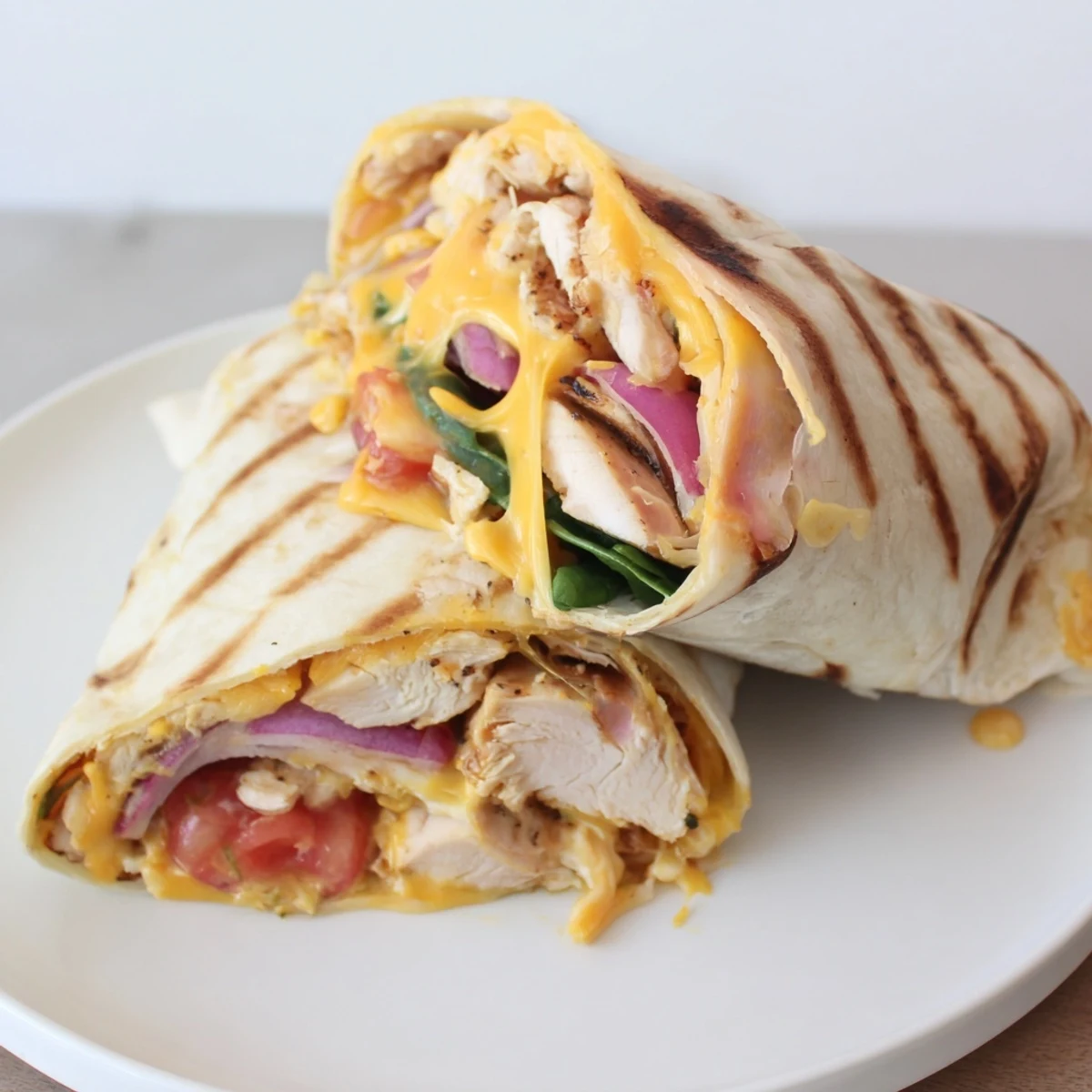 Butter-grilled Cozy Cheesy Garlic Chicken Wraps served hot with creamy garlic sauce