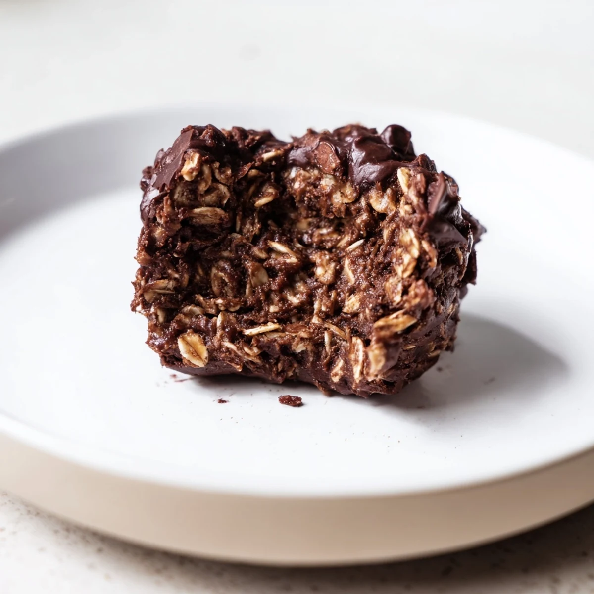 Brownie Protein Bites nestled on parchment, rich chocolate aroma and sticky texture.