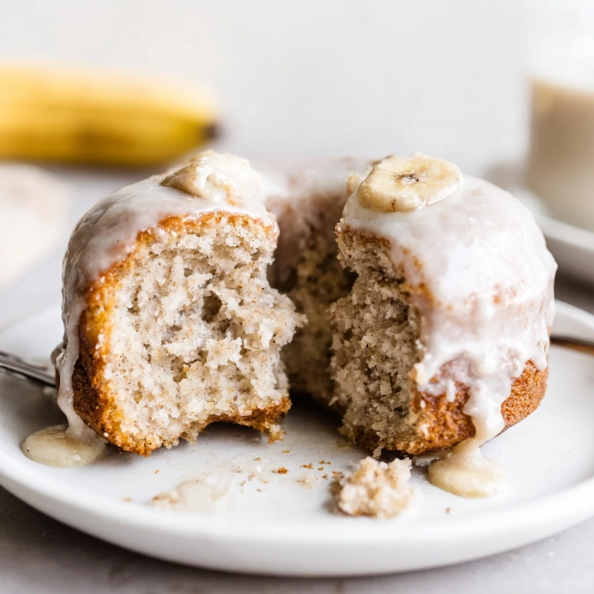 Banana Donuts glistening with vanilla glaze, golden edges and soft crumb