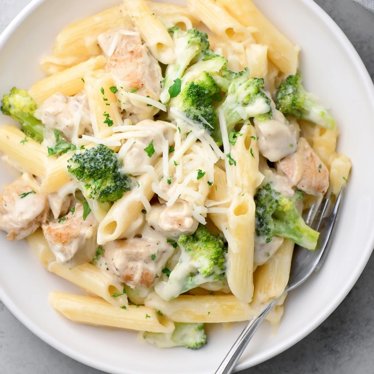 Sliced chicken and bright broccoli in Chicken Broccoli Alfredo Bake, creamy