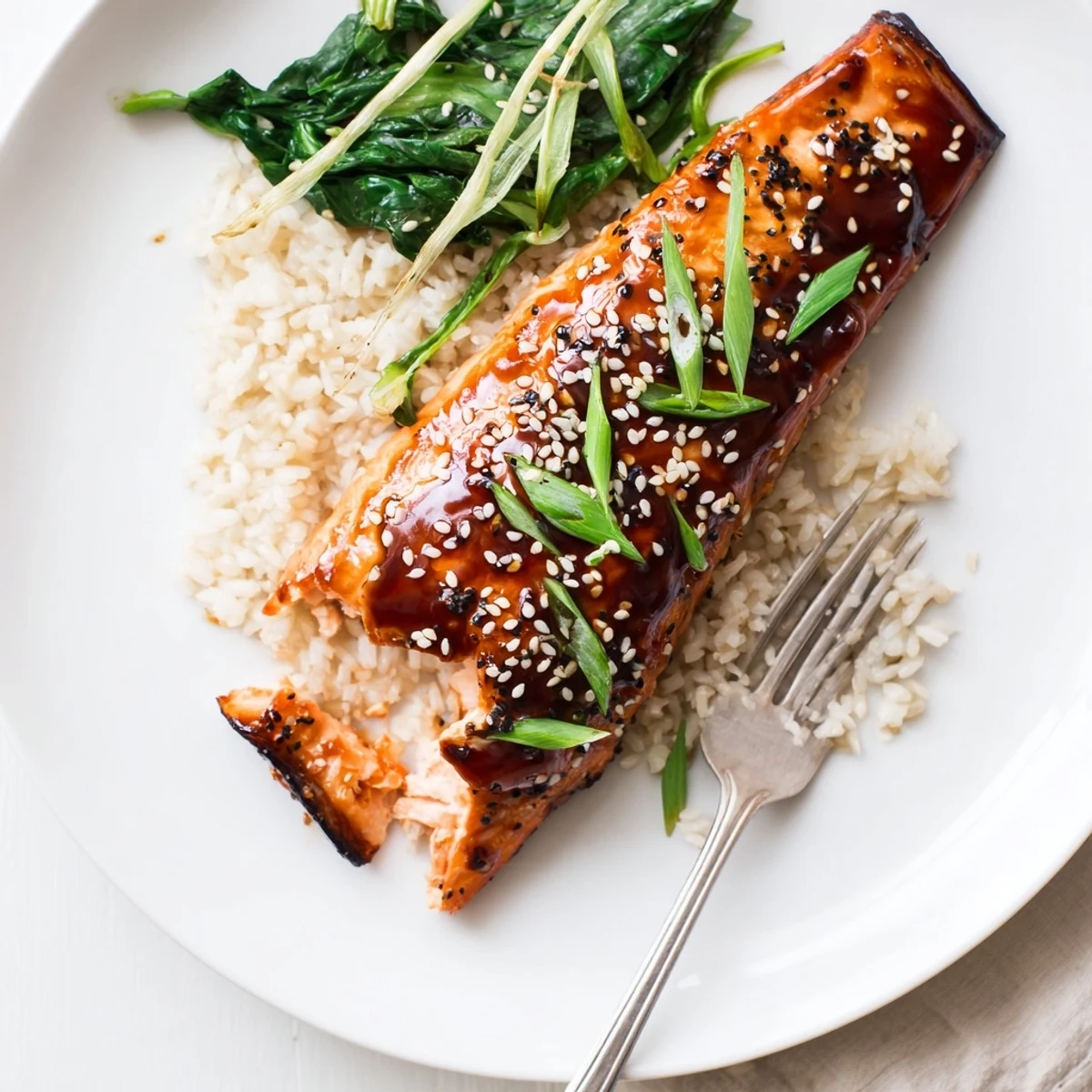 Warm Baked Teriyaki Salmon topped with toasted sesame and sliced scallions.