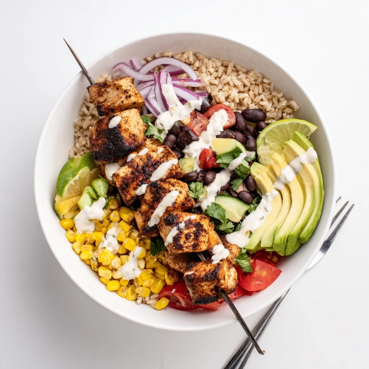 Colorful Smoky Chicken Skewer Bowl served with tangy yogurt sauce and lime