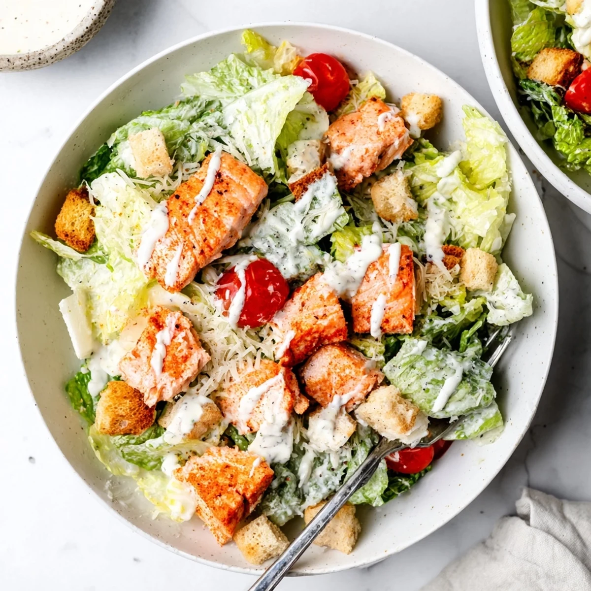Plate of charred salmon and crunchy croutons in Smoky Salmon Caesar Salad Recipe.