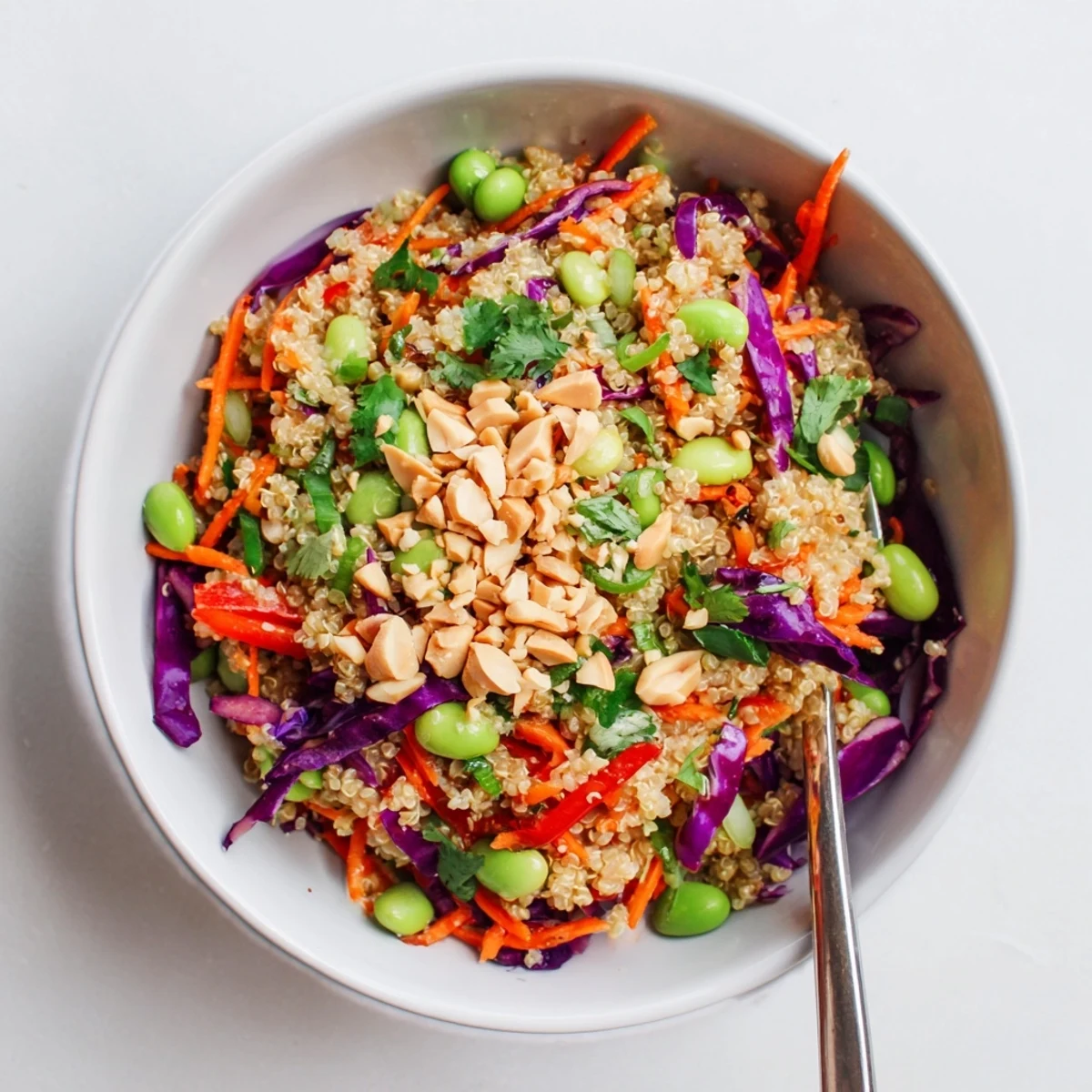 Bright Asian Dressing Quinoa Salad topped with toasted sesame seeds and peanuts