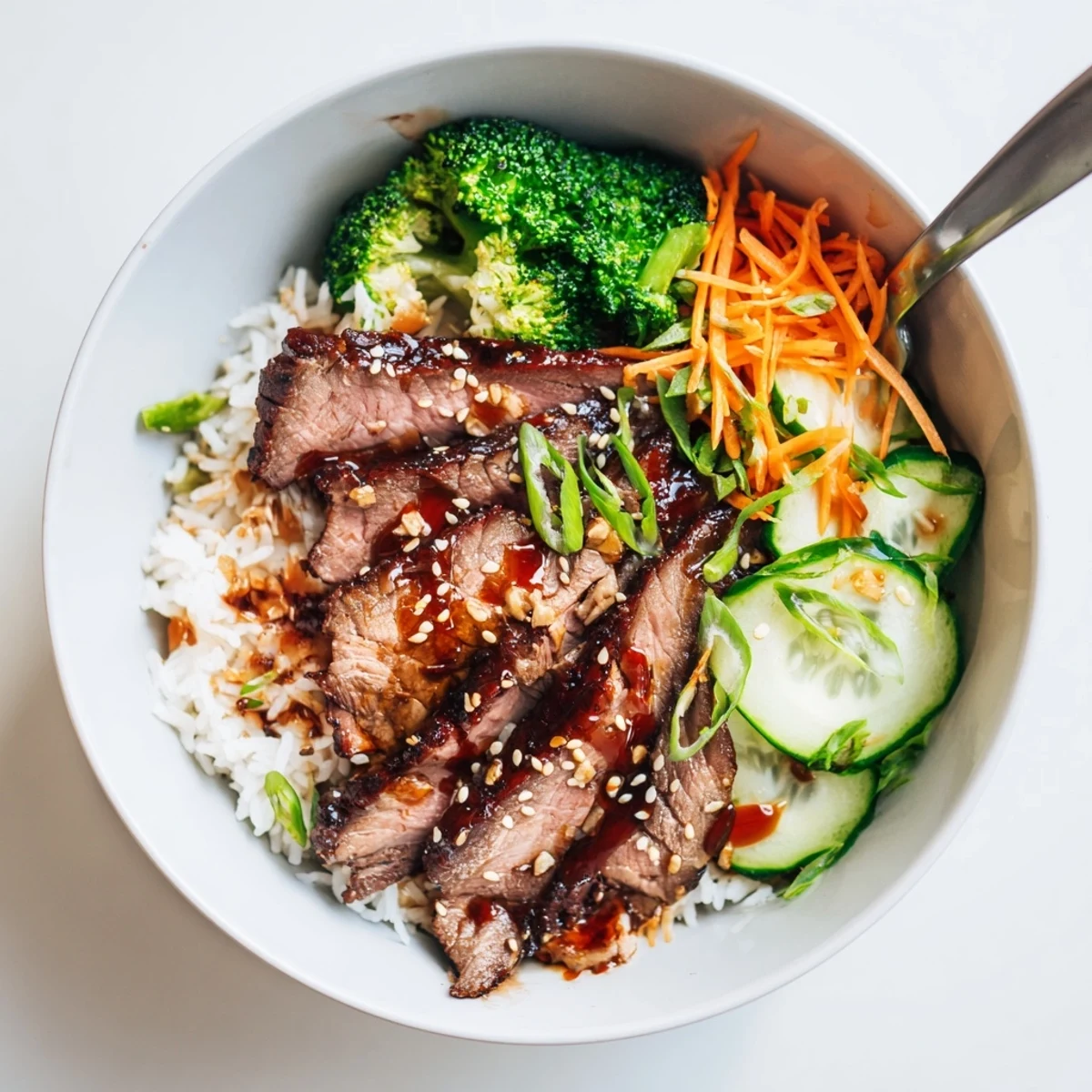 Savory Char Siu Beef Rice Bowl served warm with sriracha drizzle and veggies