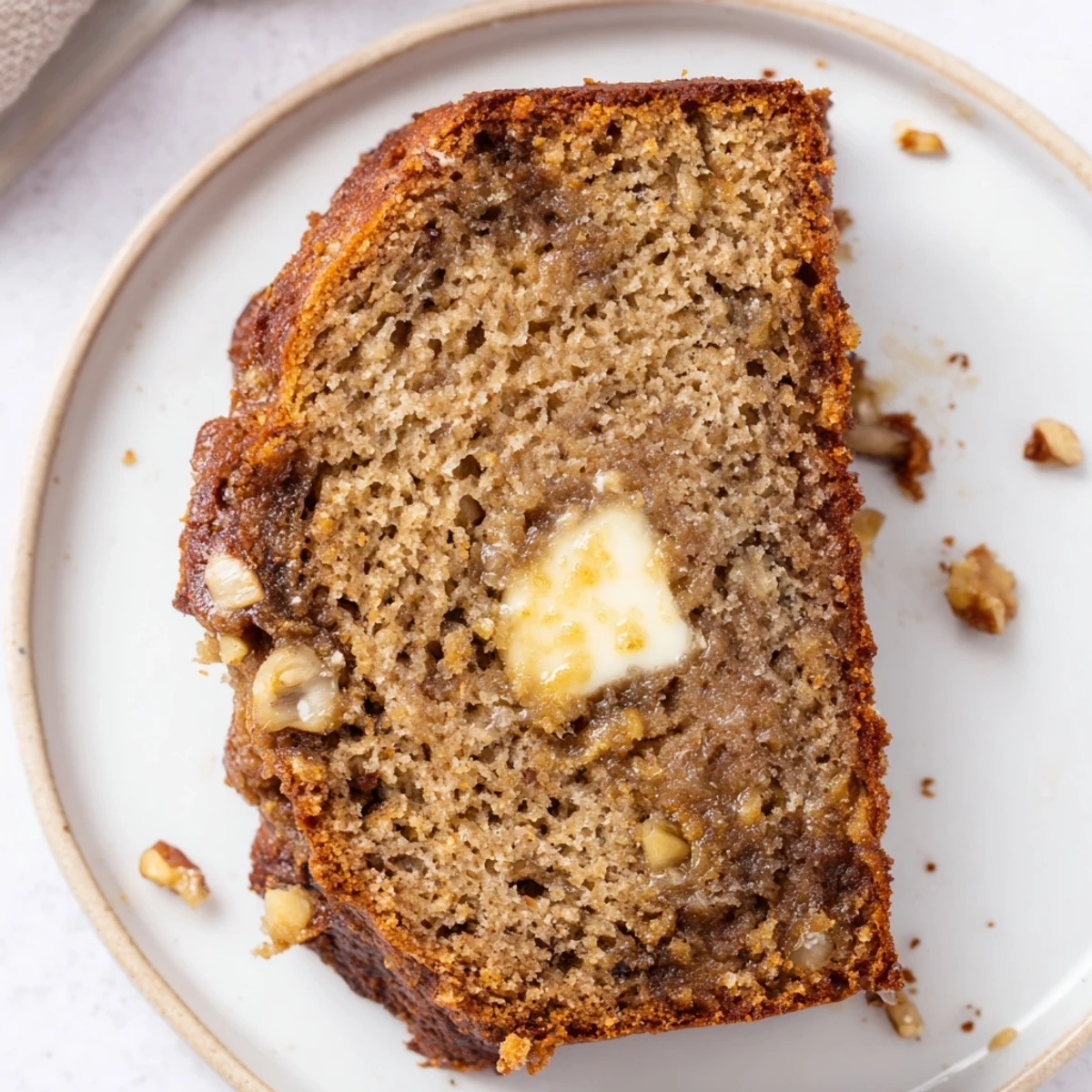 Moist Banana Bread studded with walnuts and chocolate chips, sliced thick.