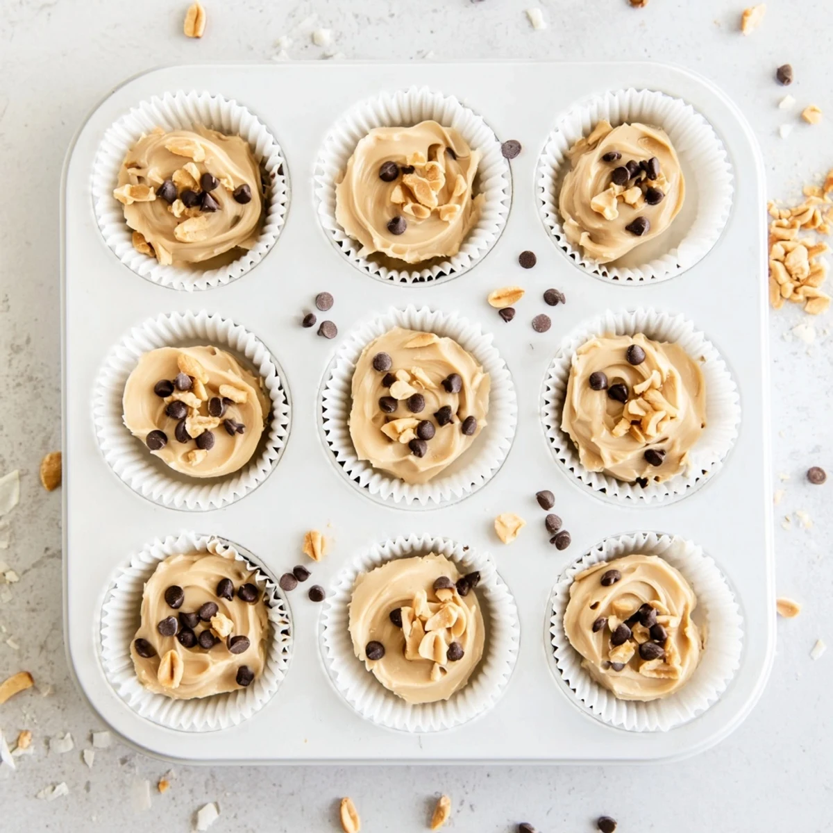 Creamy high protein frozen peanut butter Greek yogurt bites in a muffin tin ready for freezing