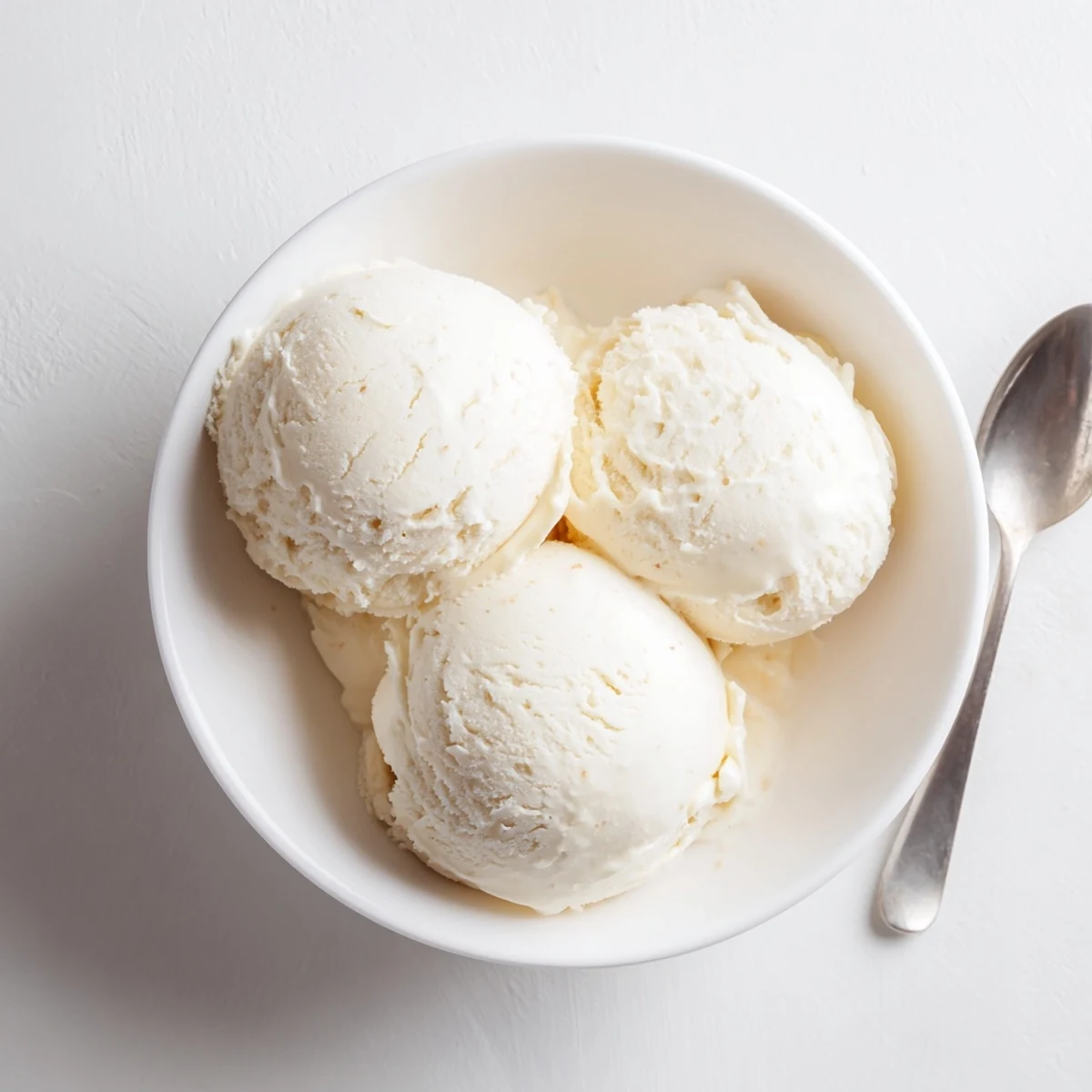 Smooth vanilla bean ice cream served in waffle cone with sprinkles on sunny day