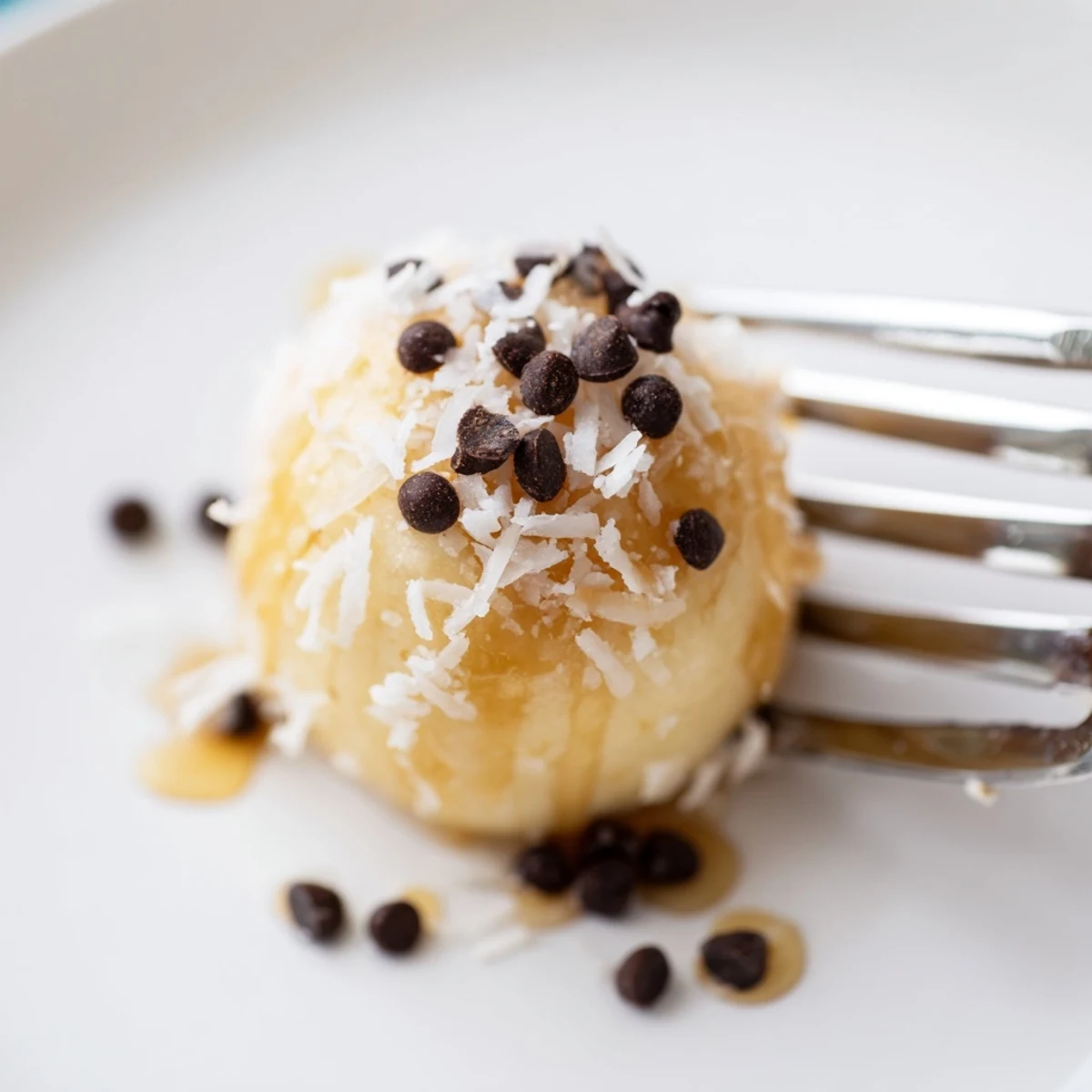 Frozen Banana Yogurt Bites chilled on parchment, creamy centers and coconut sprinkle