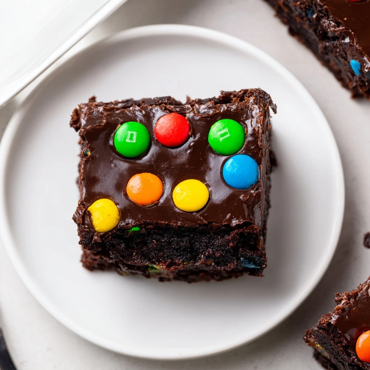 Rich, fudgy Gourmet Cosmic Brownies Bars topped with silky ganache and sprinkles