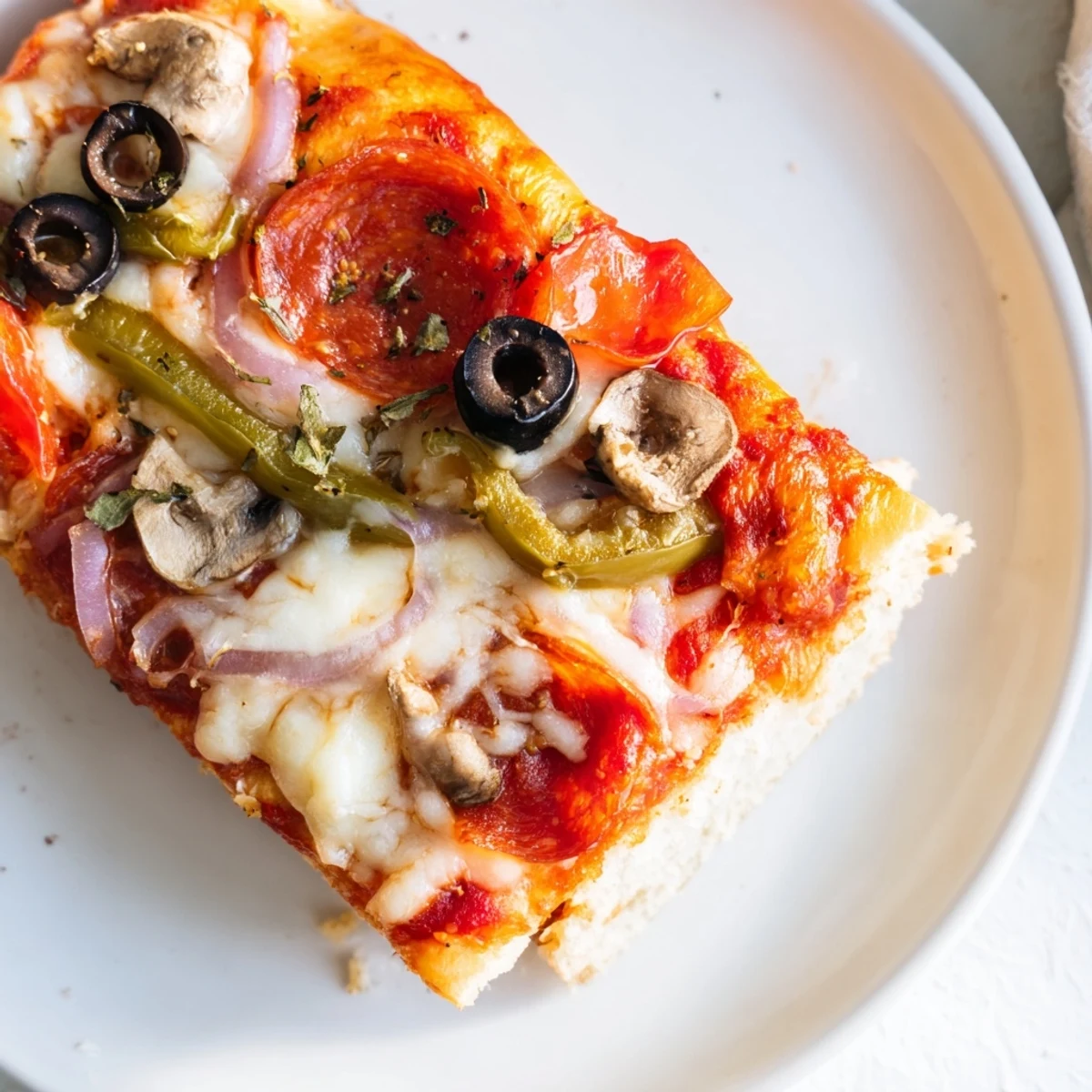 Sliced Focaccia Pizza Supreme served with crisp salad and a glass Chianti