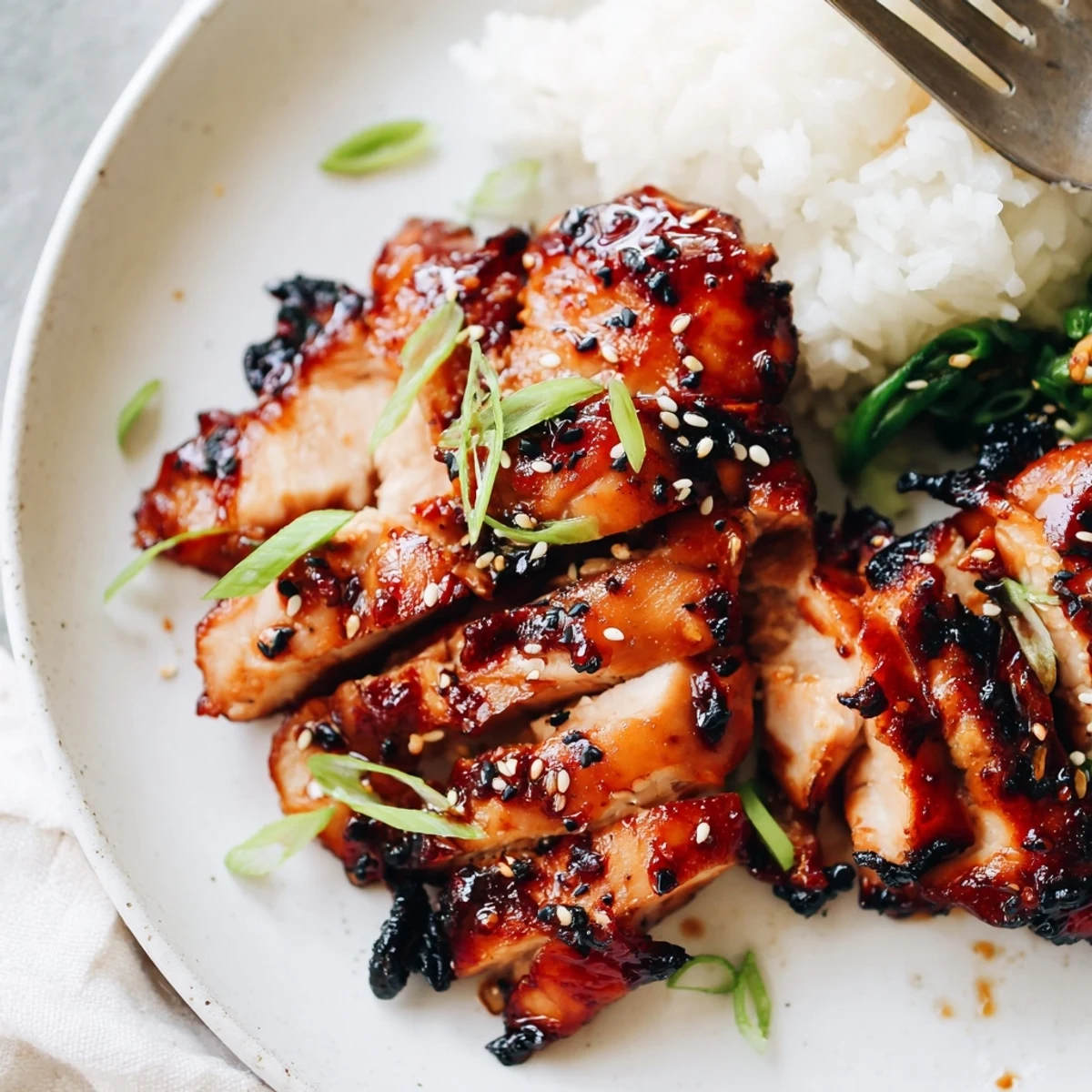 Char Siu Chicken glazed glossy and sticky, resting on steamed rice