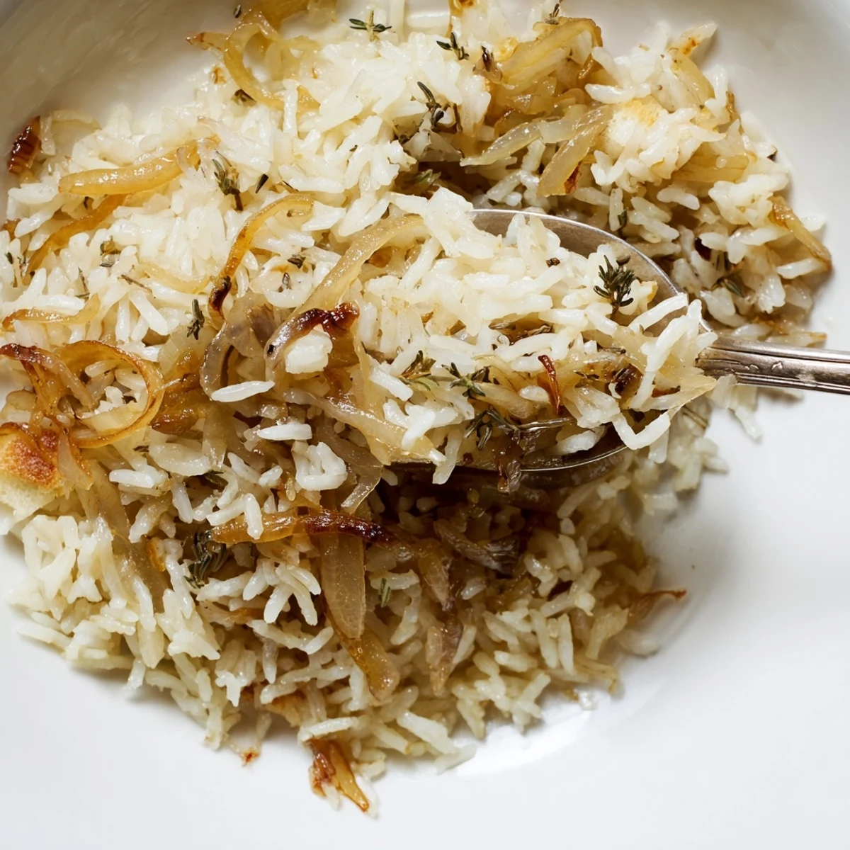 Creamy French Onion Soup Rice topped with toasted bread cubes and Parmesan