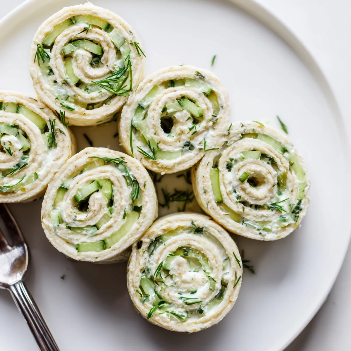 Soft tortilla spirals reveal Cucumber And Dill Pinwheels with tangy cream cheese center