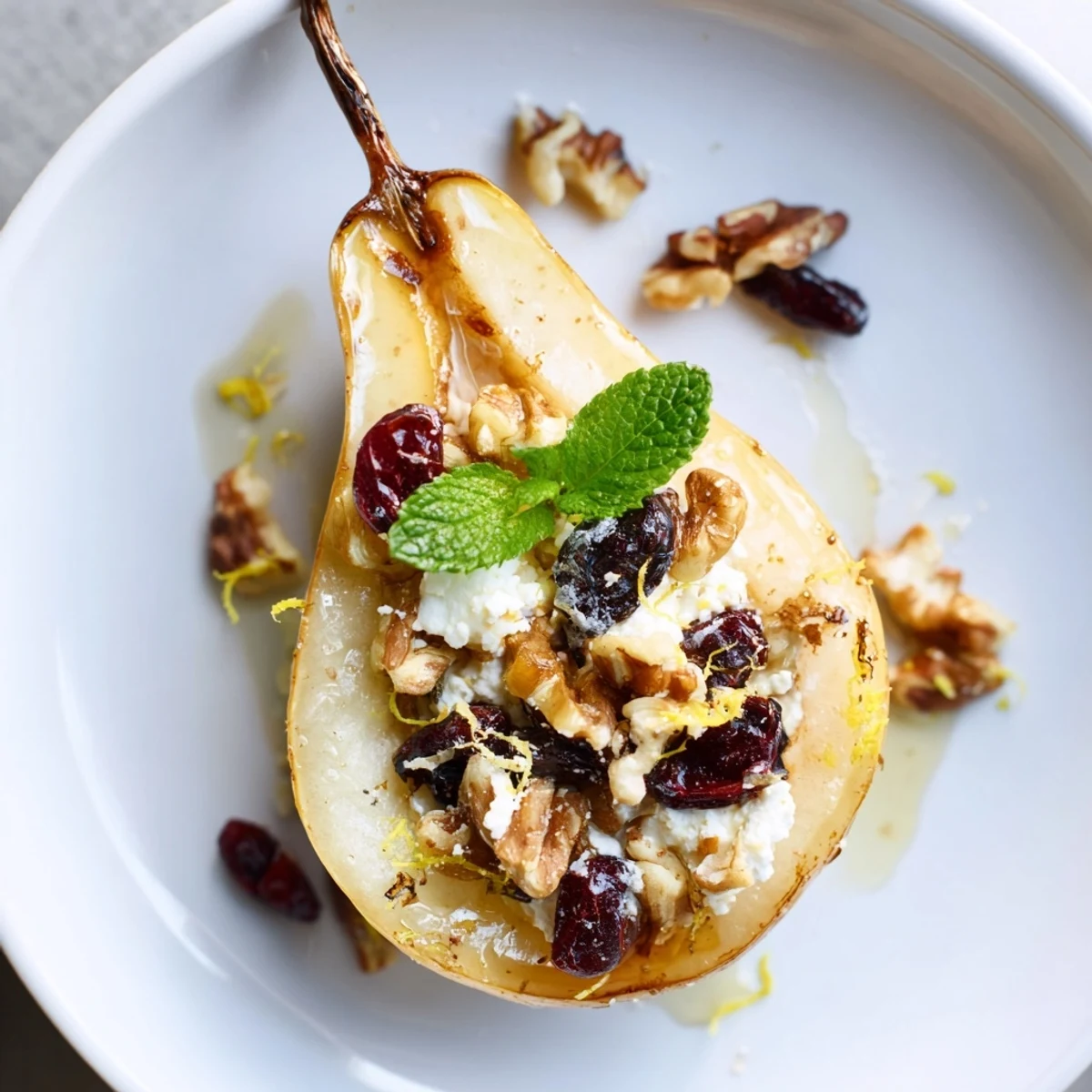 Warm Baked Pears With Feta Honey Cranberries drizzled, mint leaves garnish  