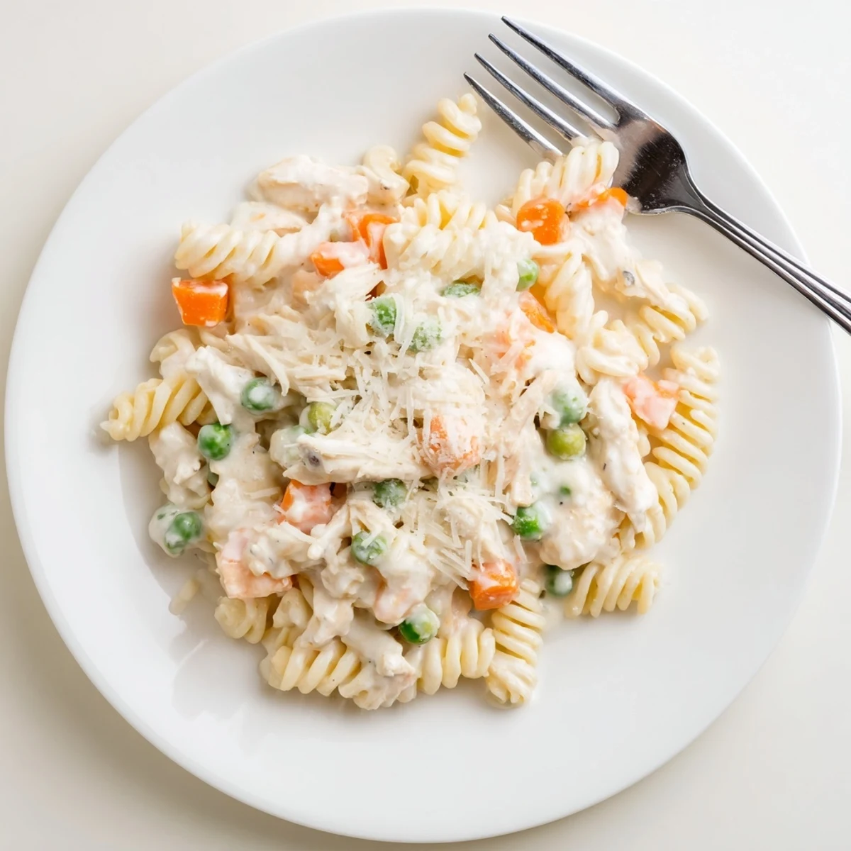 Close-up of chicken pot pie pasta showing coated rotini with diced chicken and colorful vegetables