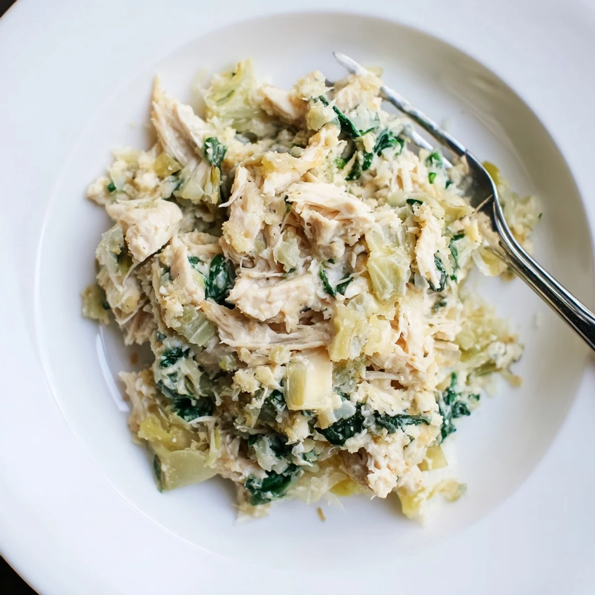 Bubbling Spinach Artichoke Chicken Casserole with golden cheese crust and crispy breadcrumbs