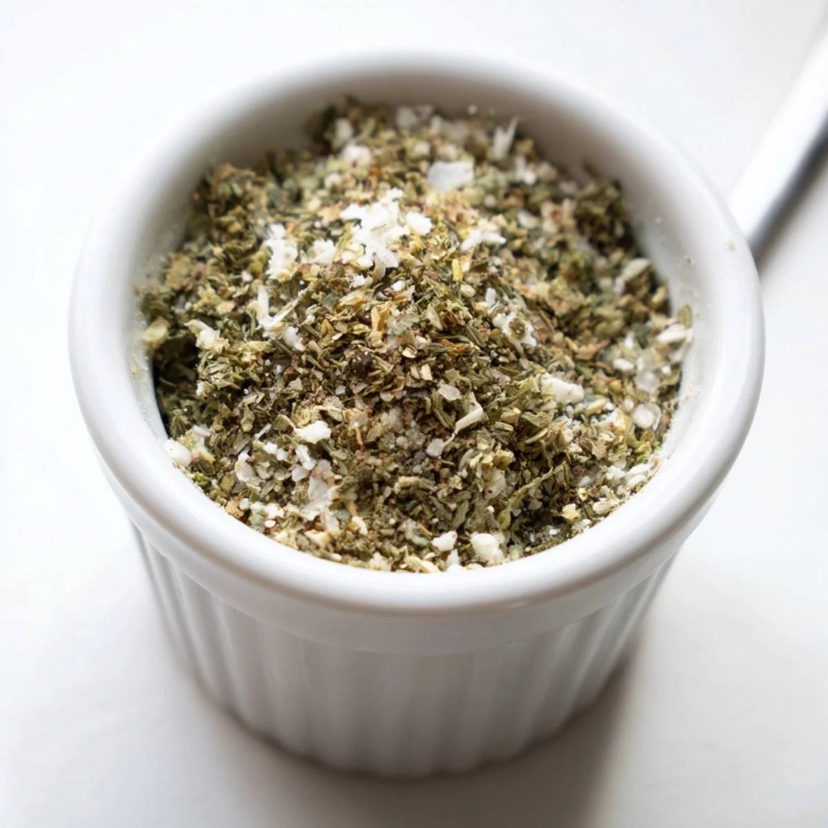 Glass jar of Dehydrated Tzatziki Seasoning Mix, herb flecks and lemon