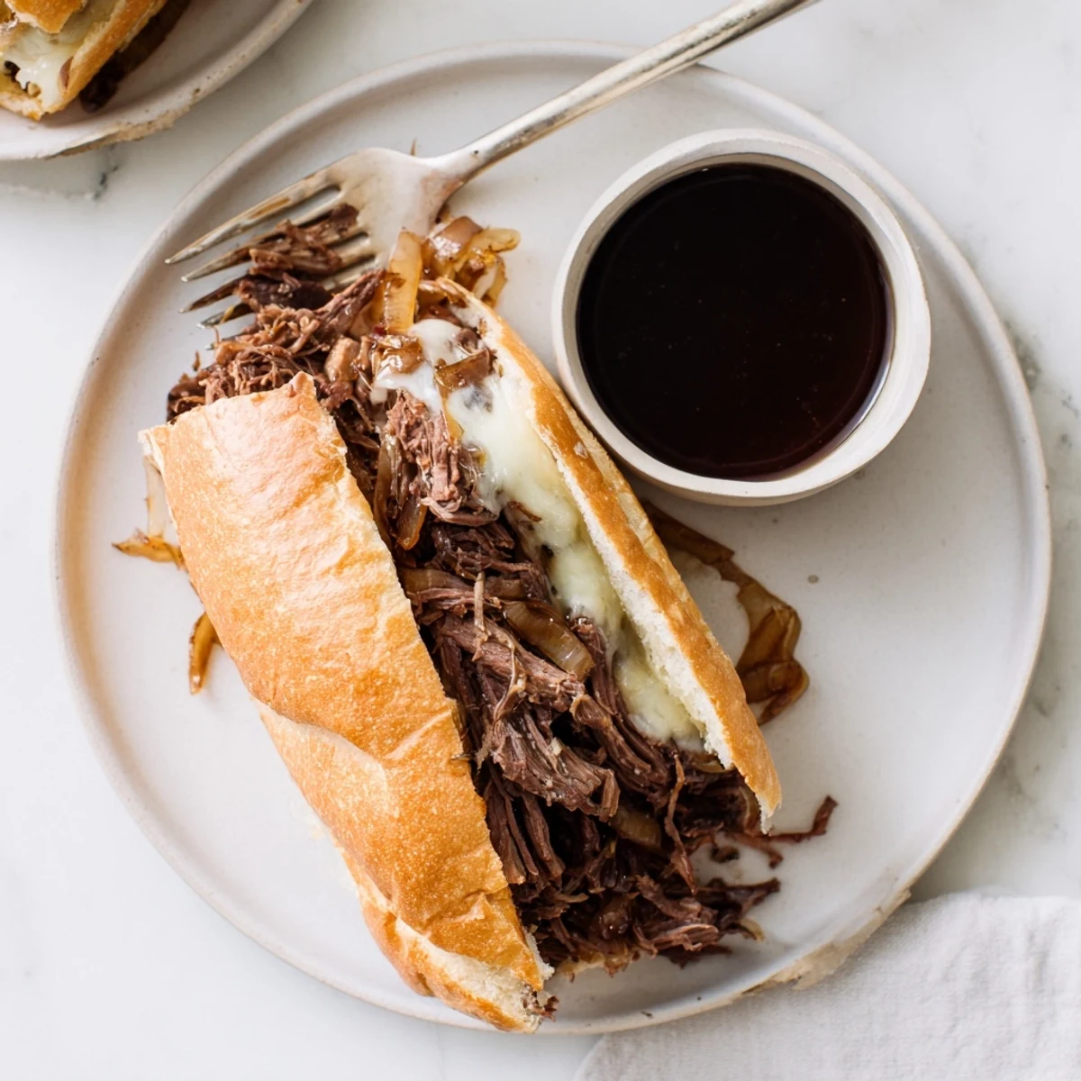 Savory Crockpot French Dip Sandwiches featuring tender shredded beef and melted provolone on toasted rolls
