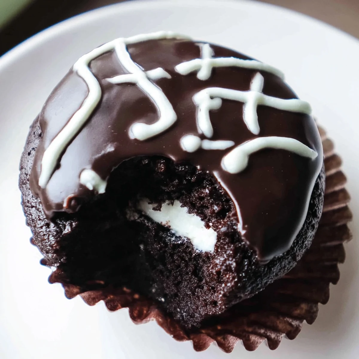 Close-up of Homemade Hostess Cupcakes showing creamy centers and iconic icing squiggle