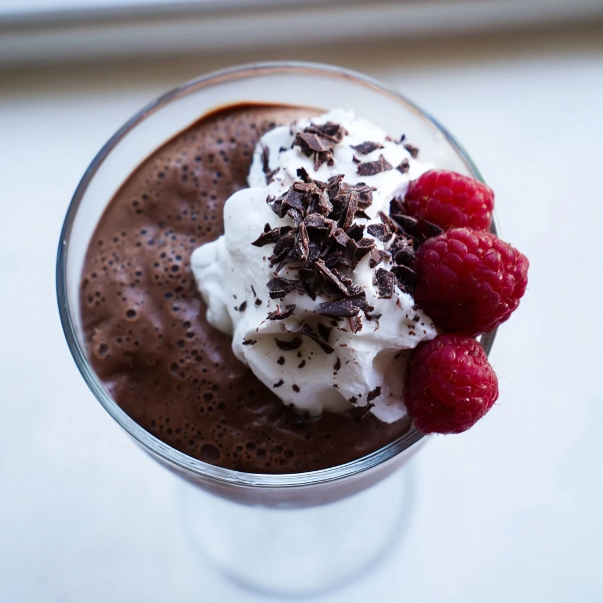 Velvety chocolate mousse spooned into ramekins with a dusting of cocoa powder