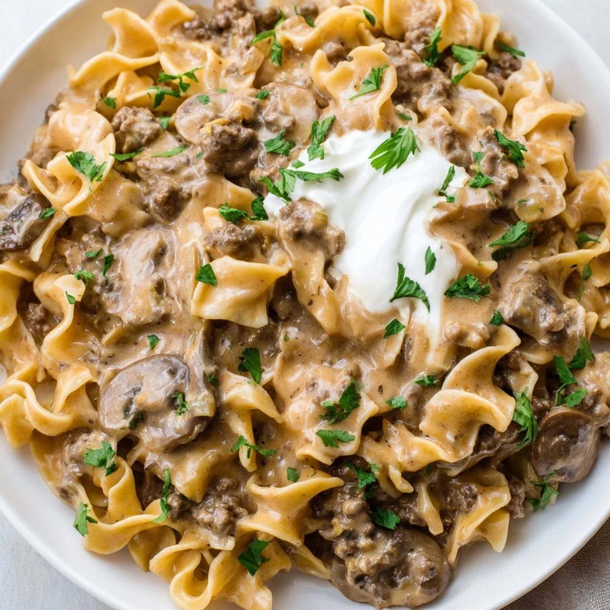 Hearty Hamburger Stroganoff featuring golden ground beef and mushrooms in rich sour cream gravy