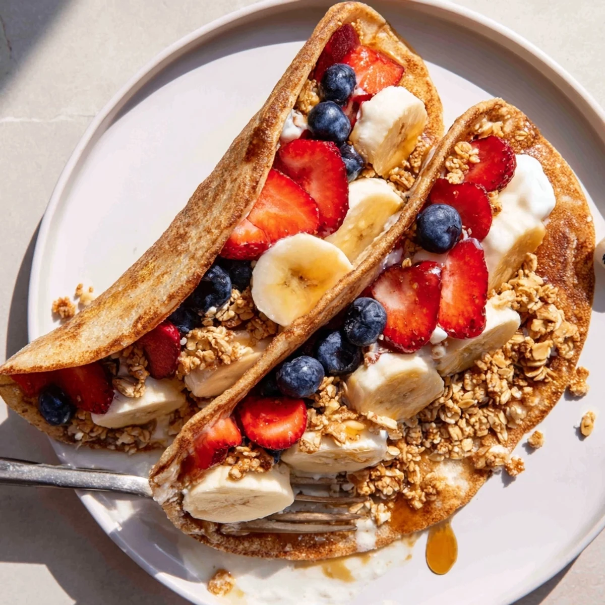 Fluffy pancake tacos filled with fresh strawberries and drizzled maple syrup
