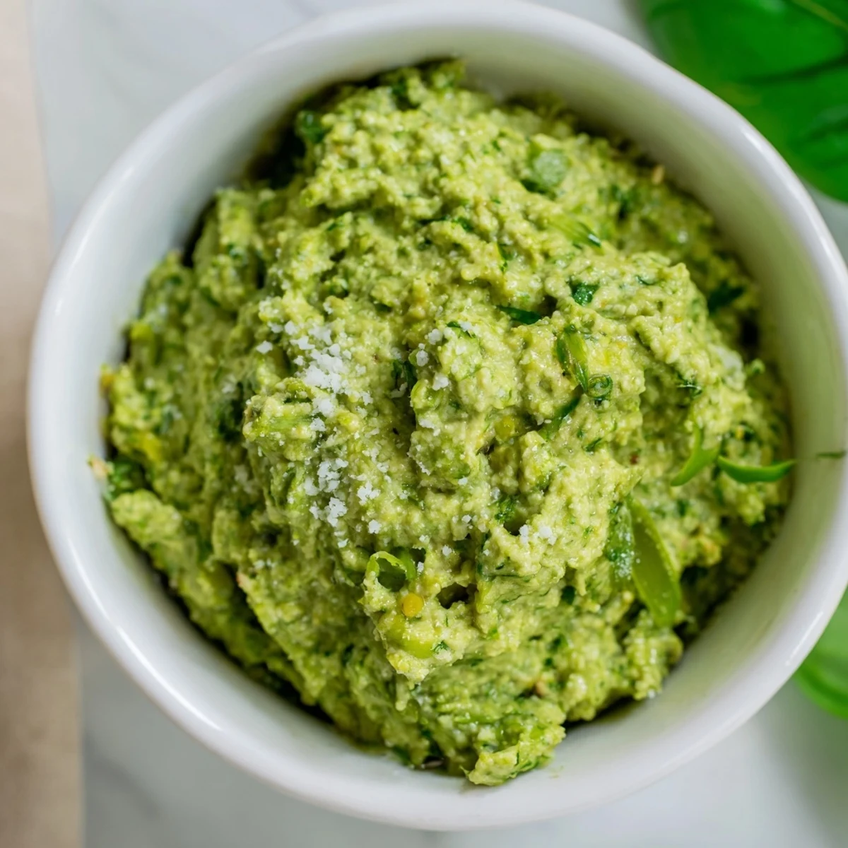 Creamy garlic scape pesto with basil drizzled over roasted vegetables.  