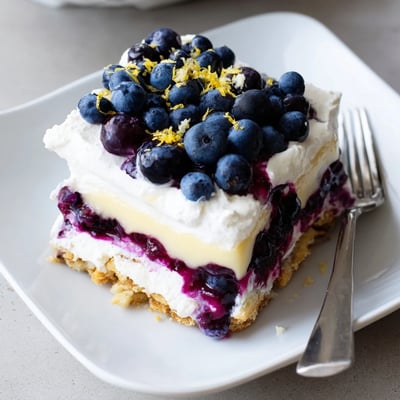 No-bake lemon blueberry lasagna topped with whipped cream and fresh berry garnish