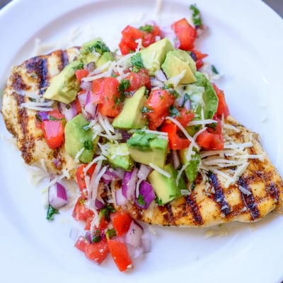 Golden seared fiesta lime chicken topped with creamy avocado and fresh cilantro