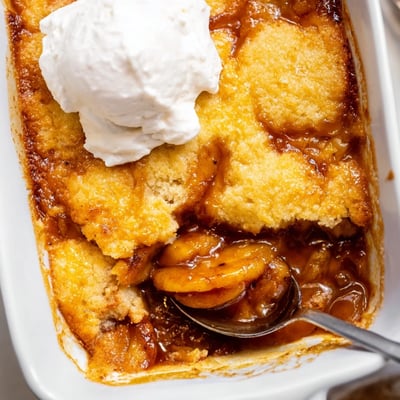 Southern banana cobbler fresh from the oven with melting vanilla ice cream