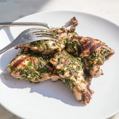 Savory Chimichurri Chicken Thighs resting on a platter with fresh parsley garnish  